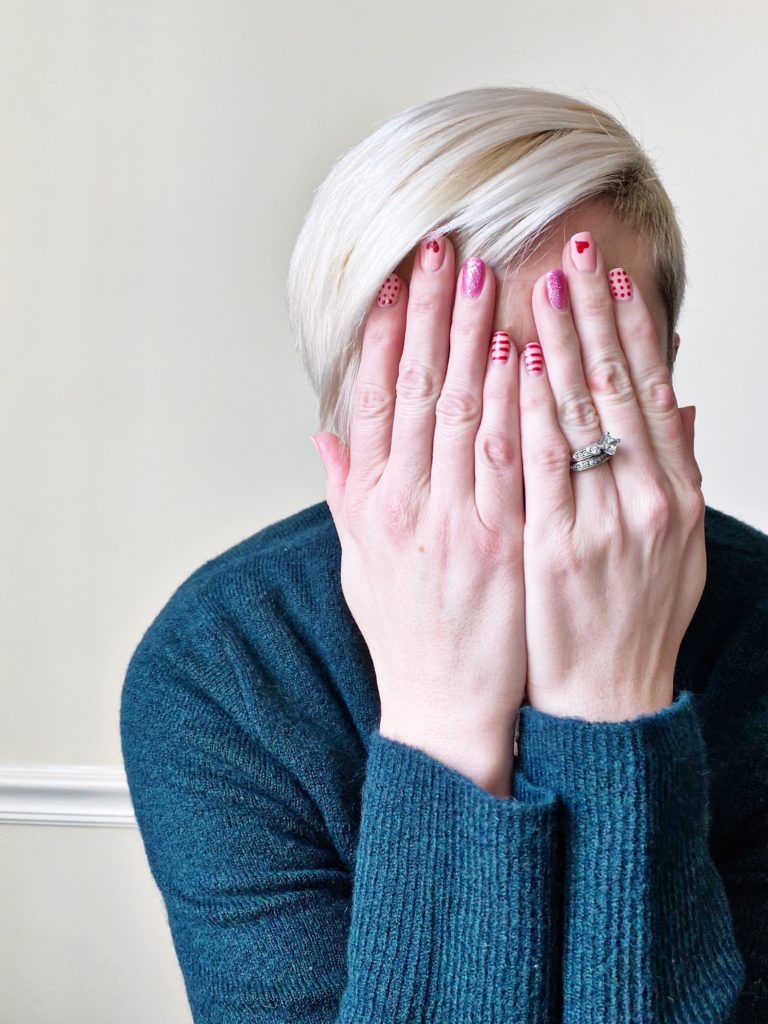 photo of hands covering face