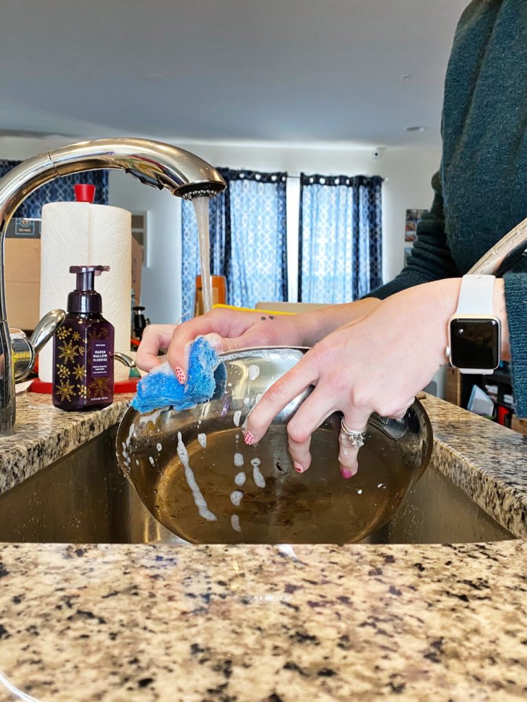 photo of hands washing dishes