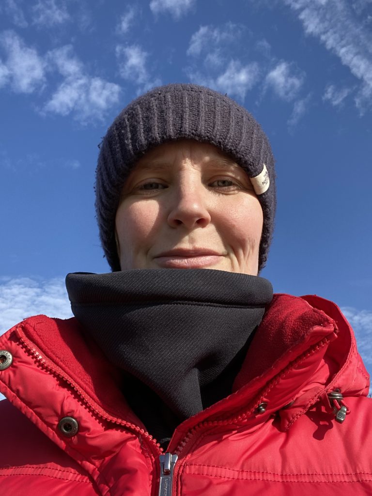 photo of my face in hat and coat with blue sky